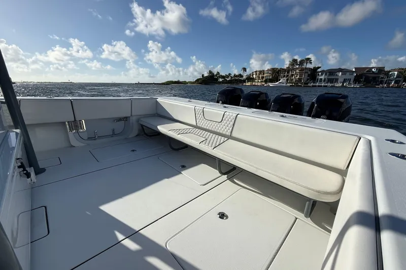  Yacht Photos Pics 2023 Contender 44 CB boat with spacious seating, ocean view, and clear blue sky.