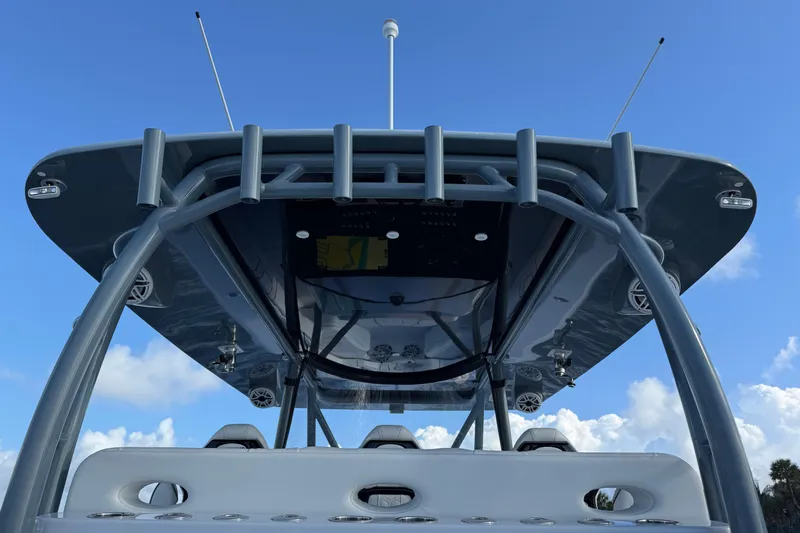 Yacht Photos Pics 2023 Contender 44 CB boat, view of the helm and T-top against a clear blue sky.