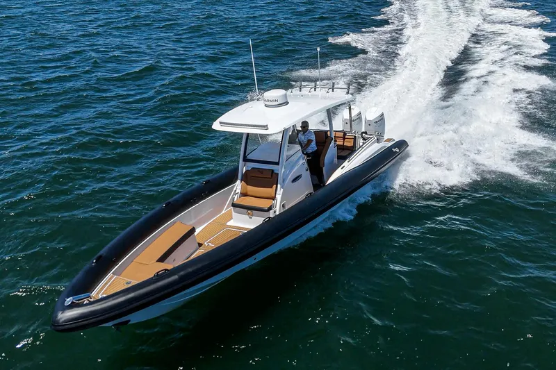 Jilly Bean Yacht Photos Pics 2025 Airship 340 boat cruising on open water, showcasing sleek design and powerful performance.