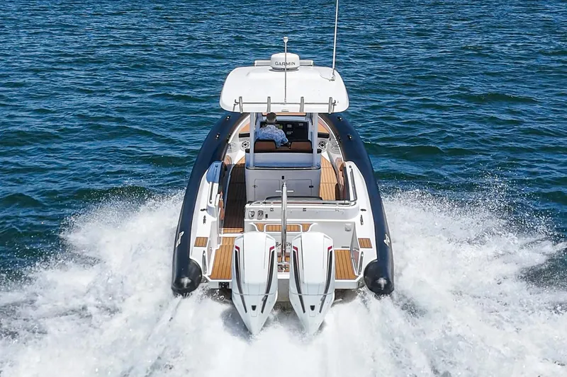 Jilly Bean Yacht Photos Pics 2025 Airship 340 boat cruising on open water, rear view.