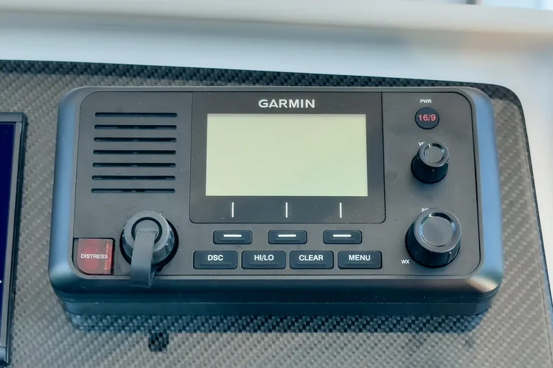 Jilly Bean Yacht Photos Pics Garmin marine radio on Airship 340, 2025 model, featuring distress button and control knobs.