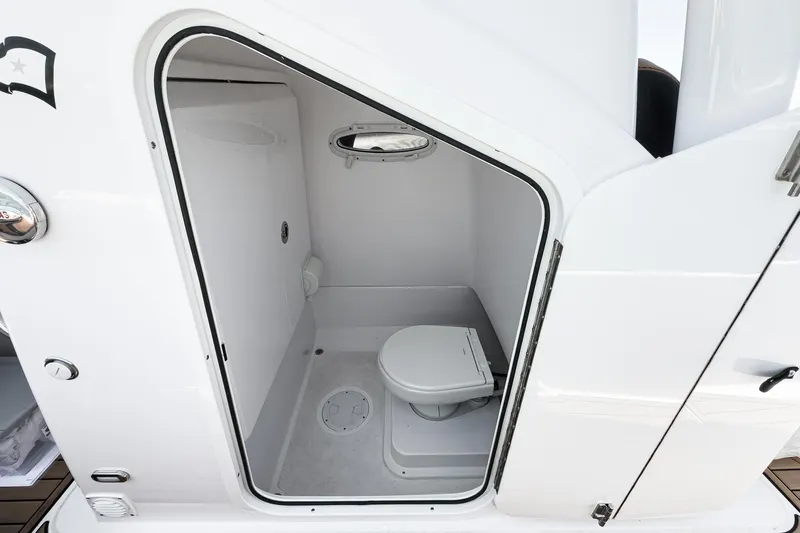 Jilly Bean Yacht Photos Pics Compact bathroom inside 2025 Airship 340 model, featuring a modern toilet and porthole window.