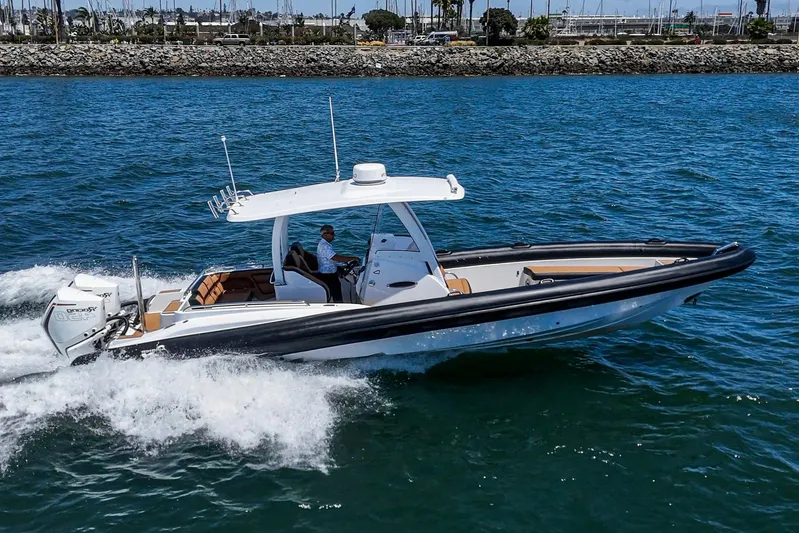 Jilly Bean Yacht Photos Pics Airship 340 boat cruising on water, 2025 model, with a person at the helm.
