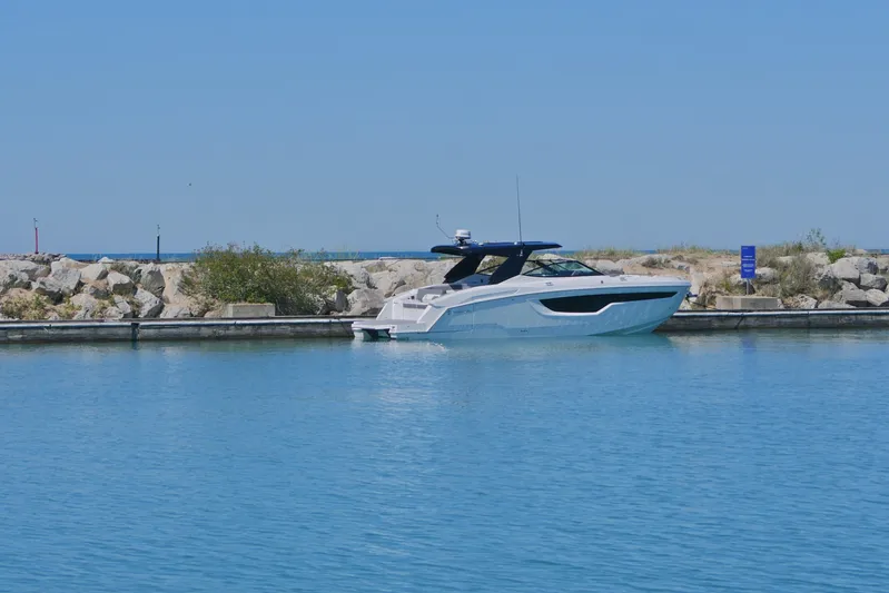  Yacht Photos Pics 2026 Cruisers Yachts 38 GLS I/O docked in a serene marina setting.