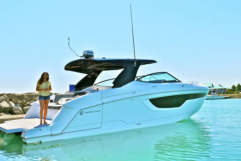  Yacht Photos Pics 2026 Cruisers Yachts 38 GLS I/O in marina, woman standing on deck.