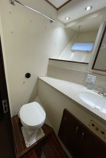 Moonshine Yacht Photos Pics 1985 Hatteras Enclosed Bridge yacht bathroom with toilet, sink, and window.