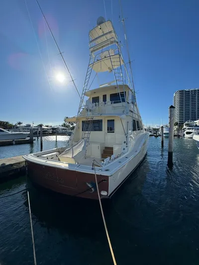 Moonshine Yacht Photos Pics 1985 Hatteras Enclosed Bridge yacht docked in sunny marina, showcasing elegant design.