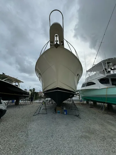 Moonshine Yacht Photos Pics 1985 Hatteras Enclosed Bridge yacht on dry dock under cloudy skies.