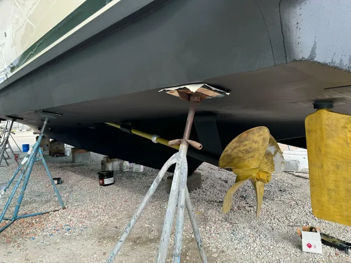 Moonshine Yacht Photos Pics 1985 Hatteras Enclosed Bridge boat under maintenance, showing propeller and hull details.
