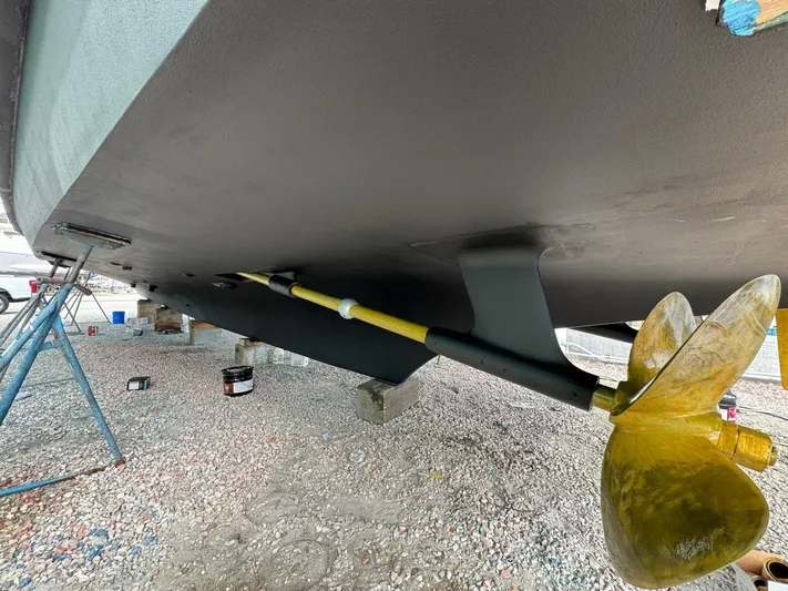 Moonshine Yacht Photos Pics 1985 Hatteras Enclosed Bridge boat underside with propeller and support stands.