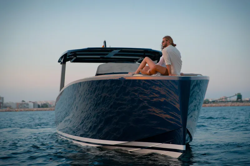  Yacht Photos Pics 2025 Tesoro T40 Inboard yacht on water with person relaxing on deck.