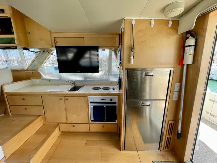 Salty Yacht Photos Pics 1999 Californian 39 yacht kitchen with stainless steel appliances and wooden cabinetry.