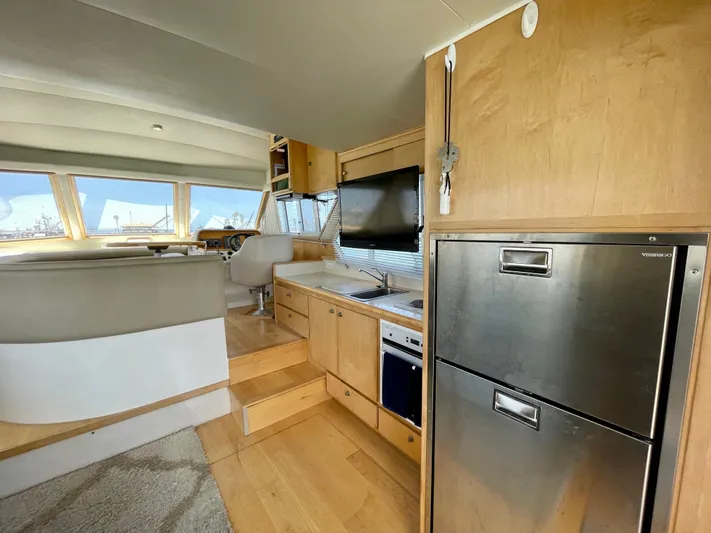 Salty Yacht Photos Pics Interior of 1999 Californian 39 yacht with modern kitchen and seating area.