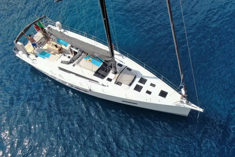  Yacht Photos Pics Aerial view of 2020 Dufour 56 Exclusive yacht sailing on clear blue water.