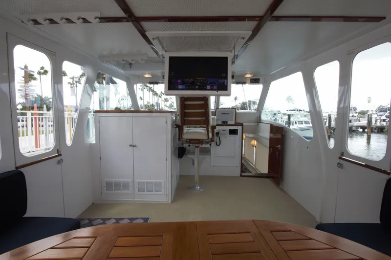  Yacht Photos Pics 1963 Huckins Linwood yacht interior with helm, seating, and panoramic windows.