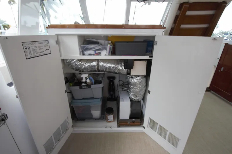  Yacht Photos Pics Interior storage compartment of a 1963 Huckins Linwood boat, featuring organized supplies and equipment.