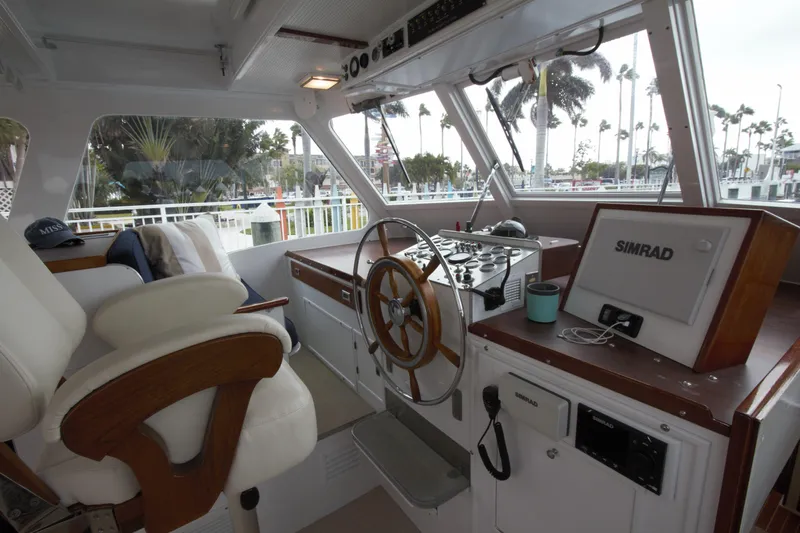  Yacht Photos Pics Interior of a 1963 Huckins Linwood boat with steering wheel and navigation equipment.
