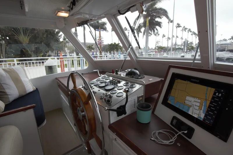  Yacht Photos Pics Interior of a 1963 Huckins Linwood boat with steering wheel and navigation system.