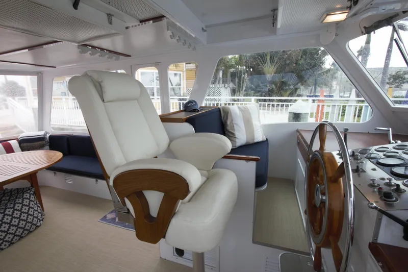  Yacht Photos Pics Interior of 1963 Huckins Linwood yacht with helm, seating, and wooden accents.