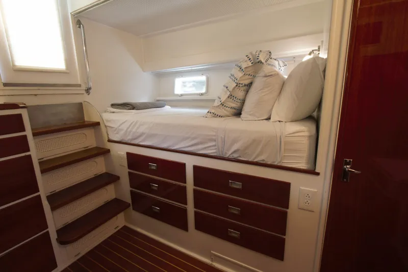  Yacht Photos Pics 1963 Huckins Linwood yacht interior with cozy bunk bed and wooden storage drawers.
