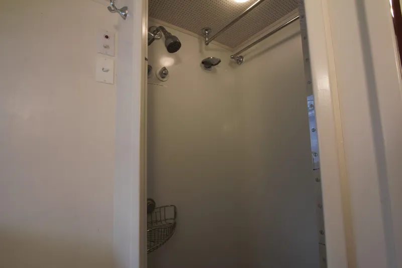 Yacht Photos Pics Shower area inside a 1963 Huckins Linwood boat, featuring multiple showerheads.