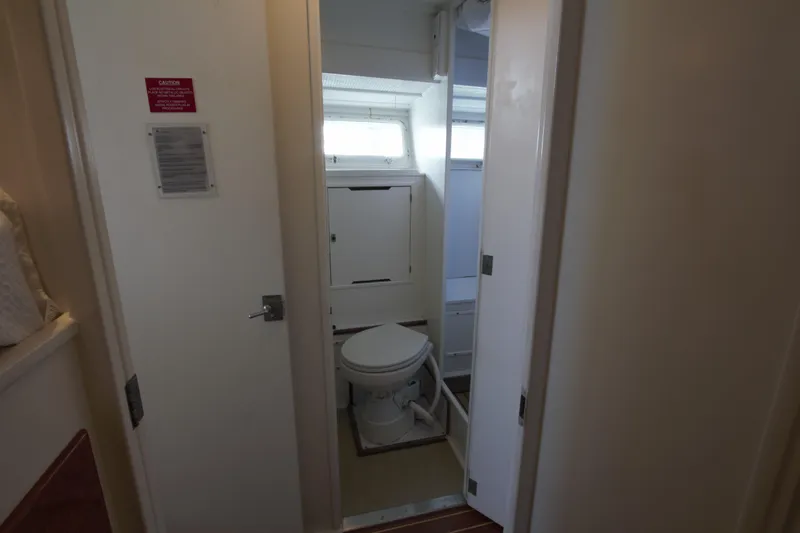  Yacht Photos Pics 1963 Huckins Linwood yacht bathroom with toilet and storage cabinets.