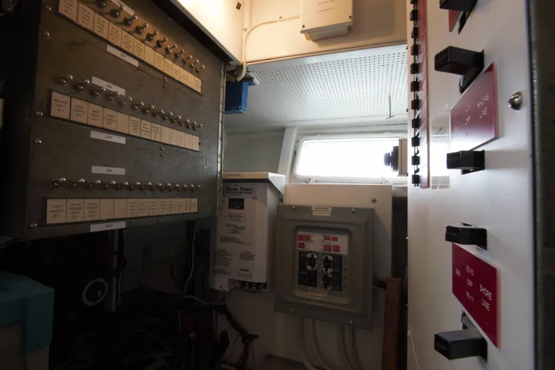  Yacht Photos Pics Electrical control room inside a 1963 Huckins Linwood boat, featuring panels and switches.