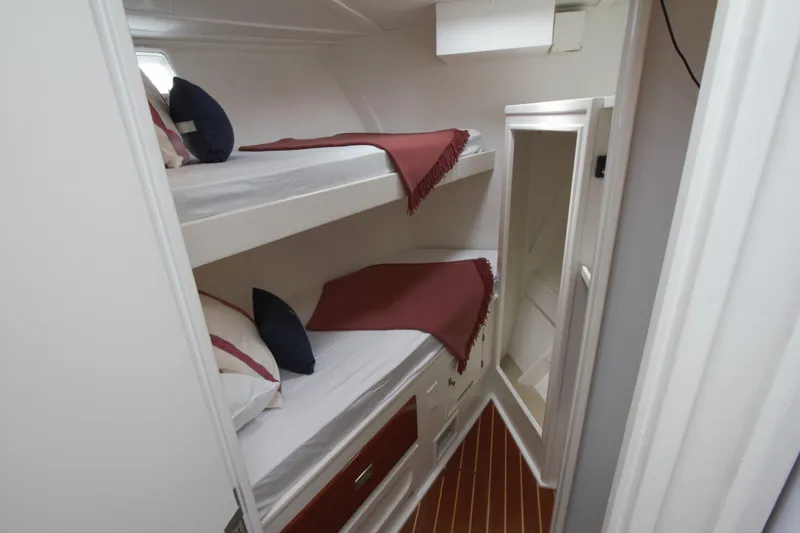  Yacht Photos Pics Bunk beds in 1963 Huckins Linwood yacht cabin with red blankets and pillows.