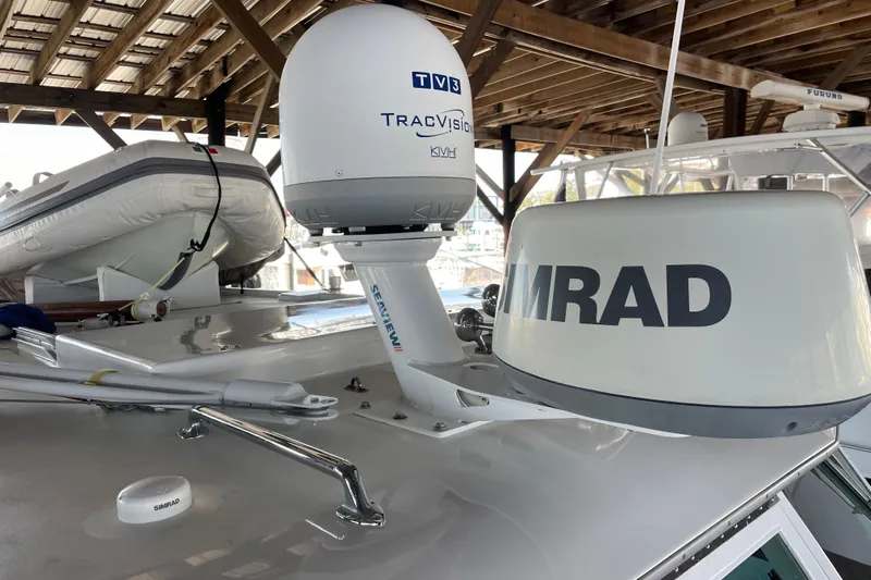  Yacht Photos Pics 1963 Huckins Linwood yacht with radar and satellite equipment under a wooden canopy.