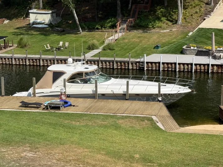  Yacht Photos Pics 1998 Sea Ray 540 Sundancer yacht docked by a scenic waterfront.