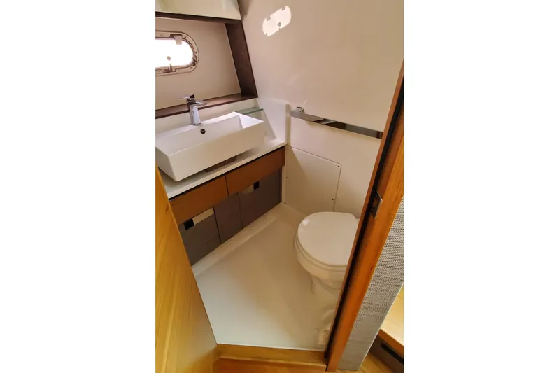 Pouge Life Yacht Photos Pics 2021 Tiara Sport 38 LS yacht bathroom with modern sink and toilet.