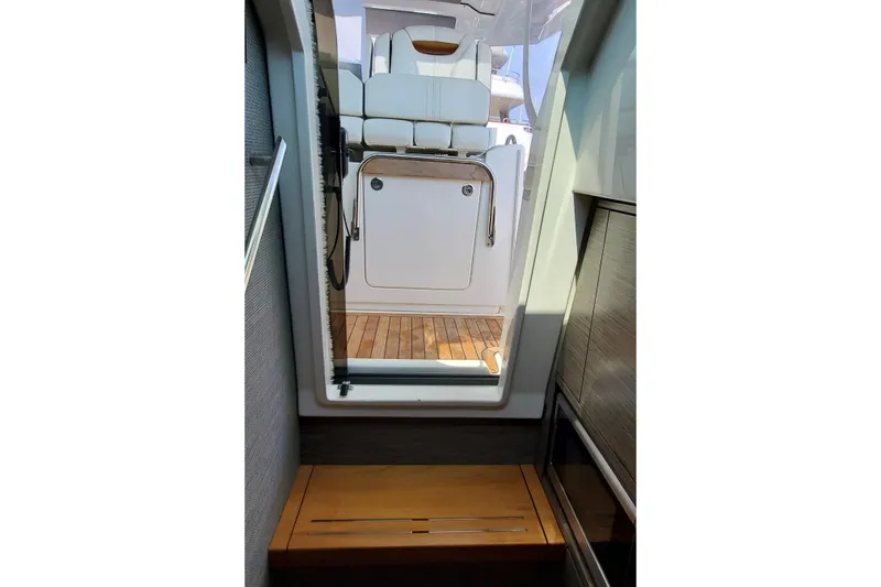 Pouge Life Yacht Photos Pics Interior view of 2021 Tiara Sport 38 LS yacht, featuring wooden flooring and seating area.