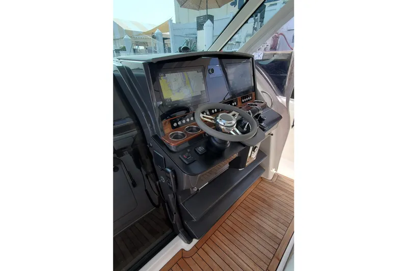 Pouge Life Yacht Photos Pics 2021 Tiara Sport 38 LS helm with dual displays and wooden accents.