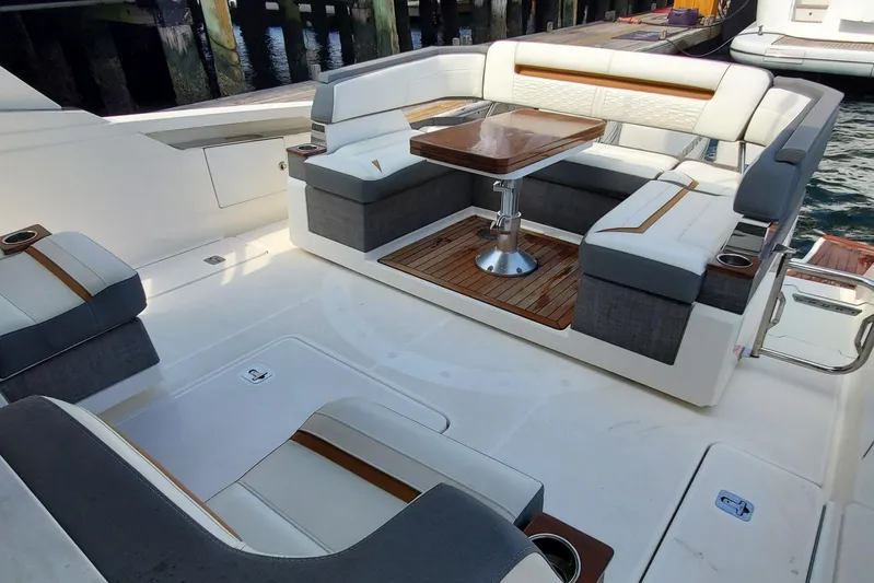 Pouge Life Yacht Photos Pics Luxurious seating area on 2021 Tiara Sport 38 LS boat with elegant table.
