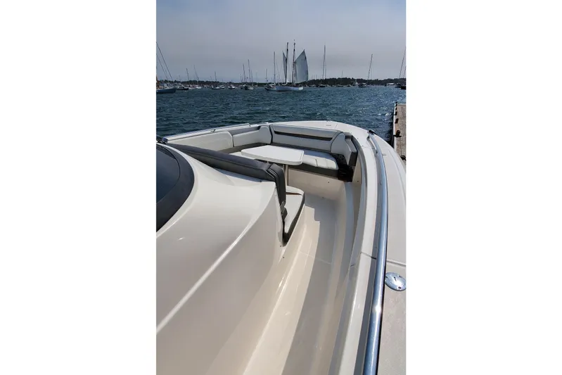 Pouge Life Yacht Photos Pics 2021 Tiara Sport 38 LS boat docked, featuring sleek design and spacious seating area.
