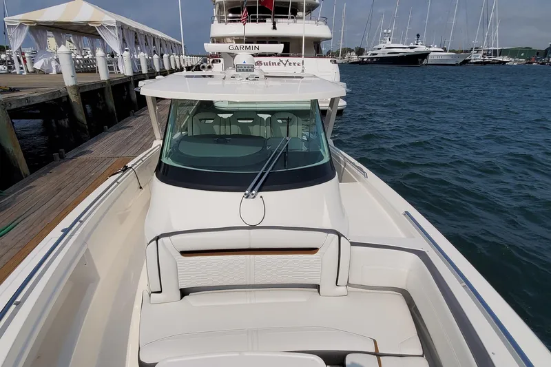 Pouge Life Yacht Photos Pics 2021 Tiara Sport 38 LS boat docked at marina, featuring sleek design and luxury seating.