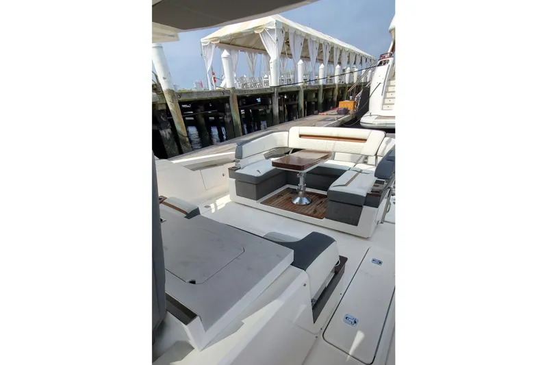 Pouge Life Yacht Photos Pics Luxurious 2021 Tiara Sport 38 LS yacht interior with elegant seating and table.