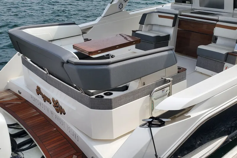 Pouge Life Yacht Photos Pics 2021 Tiara Sport 38 LS luxury yacht interior with seating and table, docked in Portsmouth.