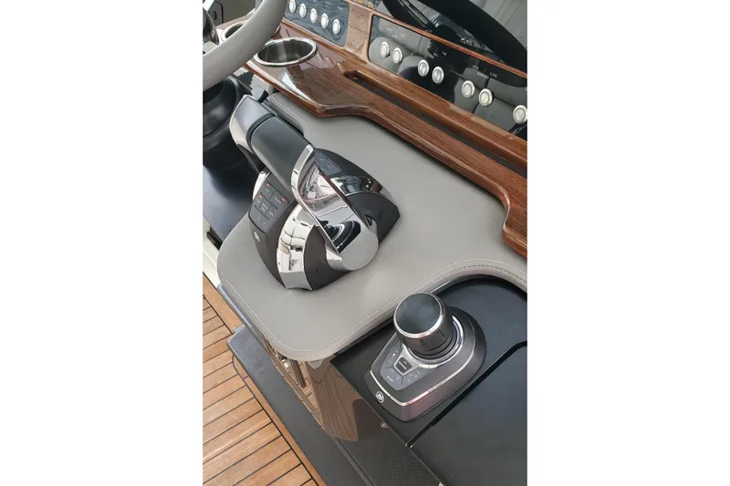 Pouge Life Yacht Photos Pics 2021 Tiara Sport 38 LS helm with modern controls and wood accents.