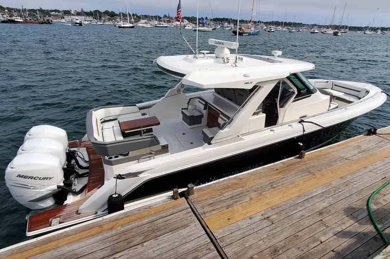Pouge Life Yacht Photos Pics 2021 Tiara Sport 38 LS boat docked, featuring Mercury engines, in a scenic marina setting.