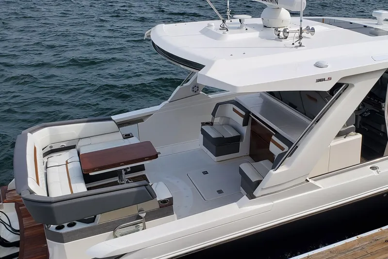 Pouge Life Yacht Photos Pics 2021 Tiara Sport 38 LS luxury boat with spacious seating and sleek design on the water.