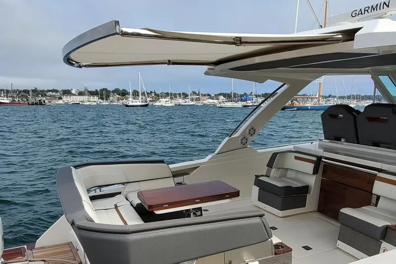 Pouge Life Yacht Photos Pics 2021 Tiara Sport 38 LS yacht interior with seating, table, and ocean view.