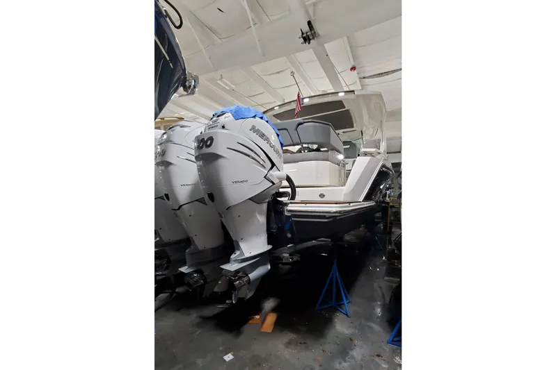 Pouge Life Yacht Photos Pics 2021 Tiara Yachts 38 LS with dual Mercury outboard engines in a showroom.