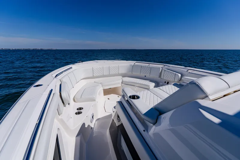 Blue Skies Yacht Photos Pics 2022 Pursuit S 378 Sport boat with luxurious seating on open water.