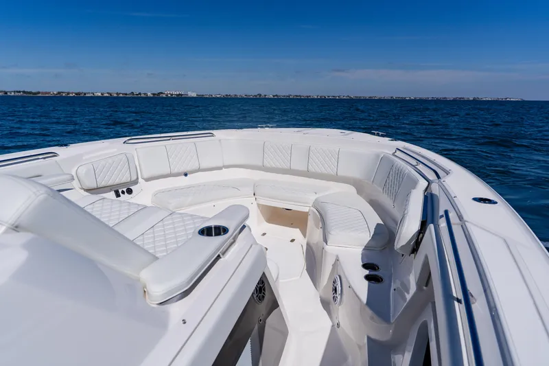 Blue Skies Yacht Photos Pics 2022 Pursuit S 378 Sport boat with luxurious seating on open water.