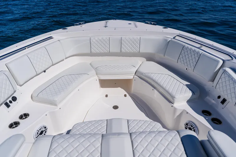 Blue Skies Yacht Photos Pics 2022 Pursuit S 378 Sport boat interior with luxurious white seating and ocean backdrop.