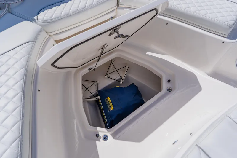 Blue Skies Yacht Photos Pics 2022 Pursuit S 378 Sport boat storage compartment with cushioned seating.
