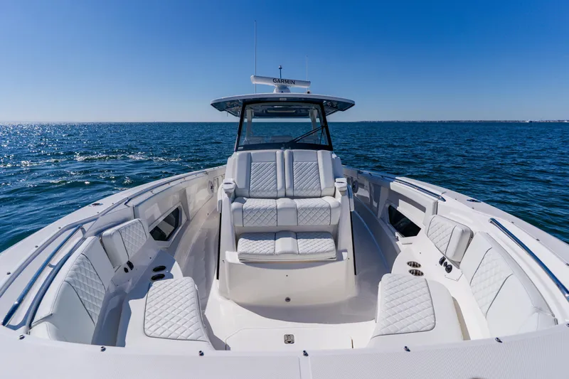 Blue Skies Yacht Photos Pics 2022 Pursuit S 378 Sport boat on open water, featuring luxurious seating and sleek design.
