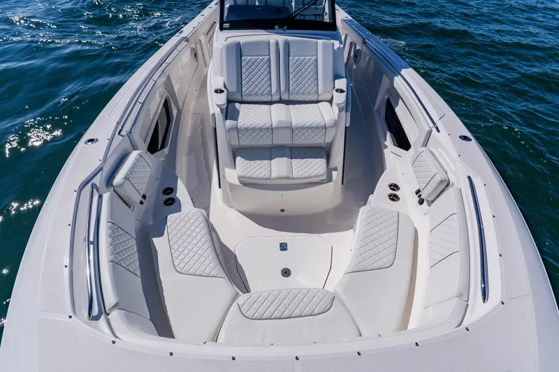 Blue Skies Yacht Photos Pics 2022 Pursuit S 378 Sport boat with luxurious seating on open water.