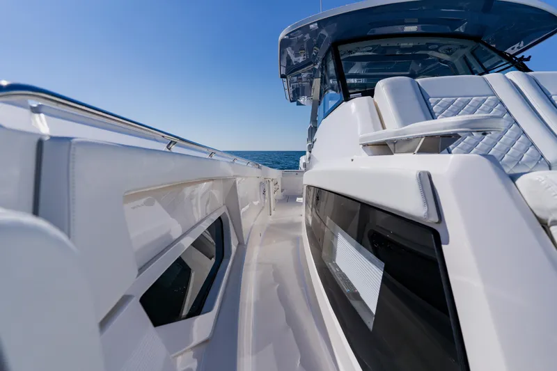 Blue Skies Yacht Photos Pics 2022 Pursuit S 378 Sport boat, sleek design, ocean view, sunny day.